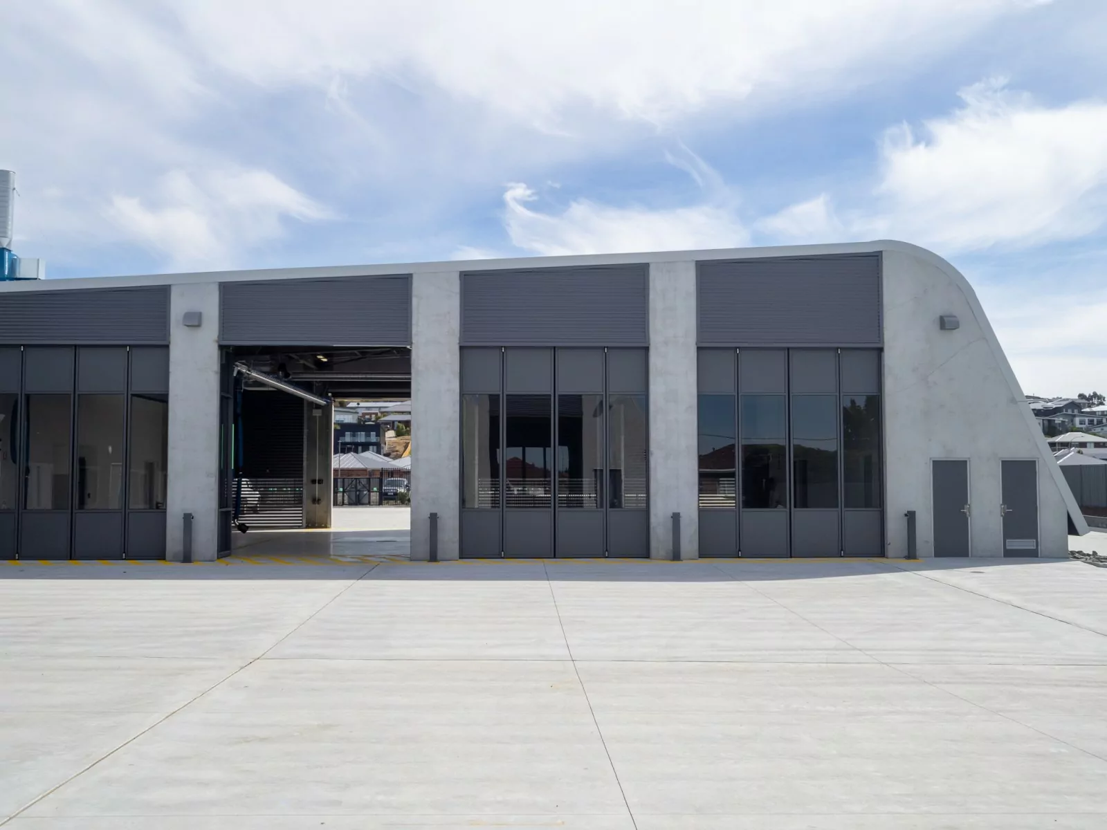 Sorell Emergency Services Hub, Tasmania. A concrete garage structure with glass paneled folding doors shows the spaces for emergency services vehicles.