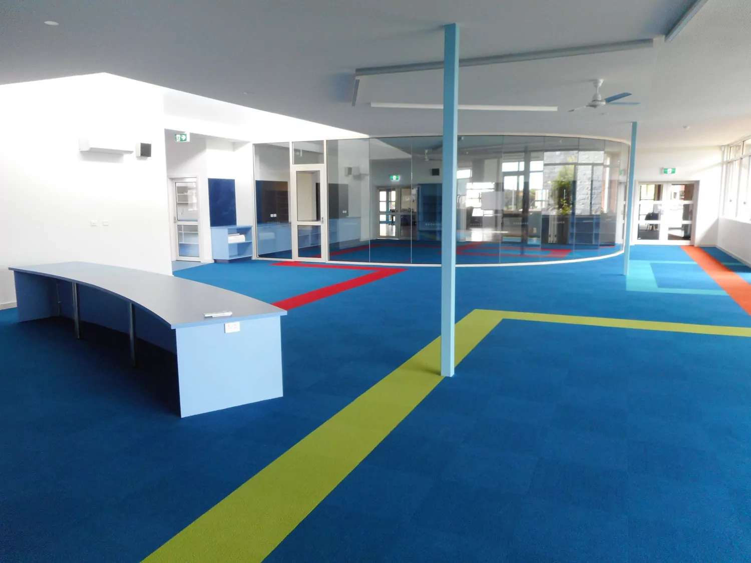The bright paintwork, colourful carpets of the learning area of the All Saints Primary School.