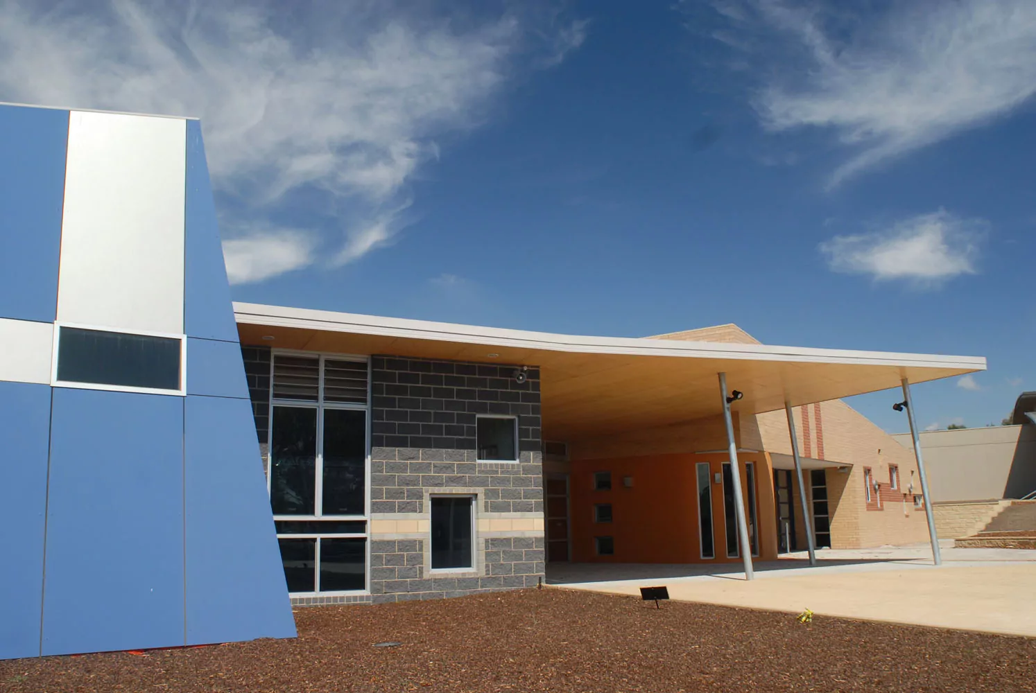 The grey, cream brickwork and blue concrete walls of the modernly designed Arts & Technology facility at Assumption College, Kilmore.