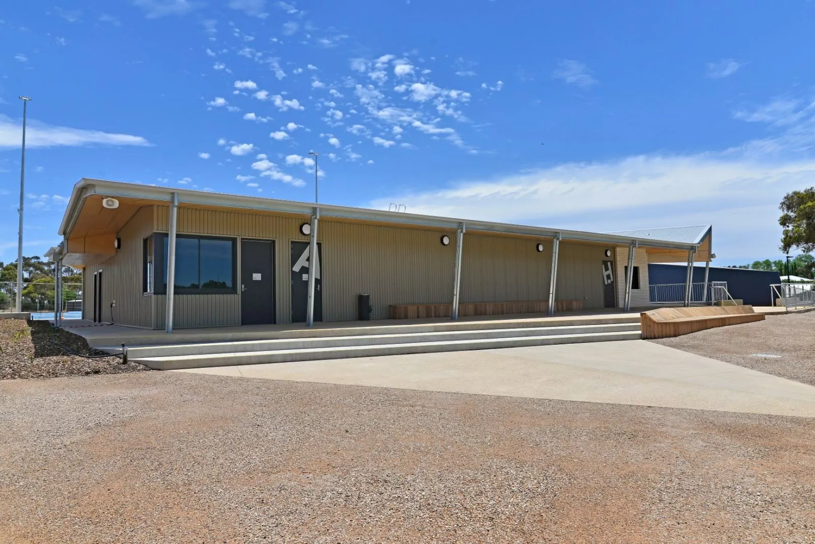 The recreation pavilion of the Wesley Hill Sporting Precinct. On the three doors, there is a large A and H letter on one of the doors respectively.