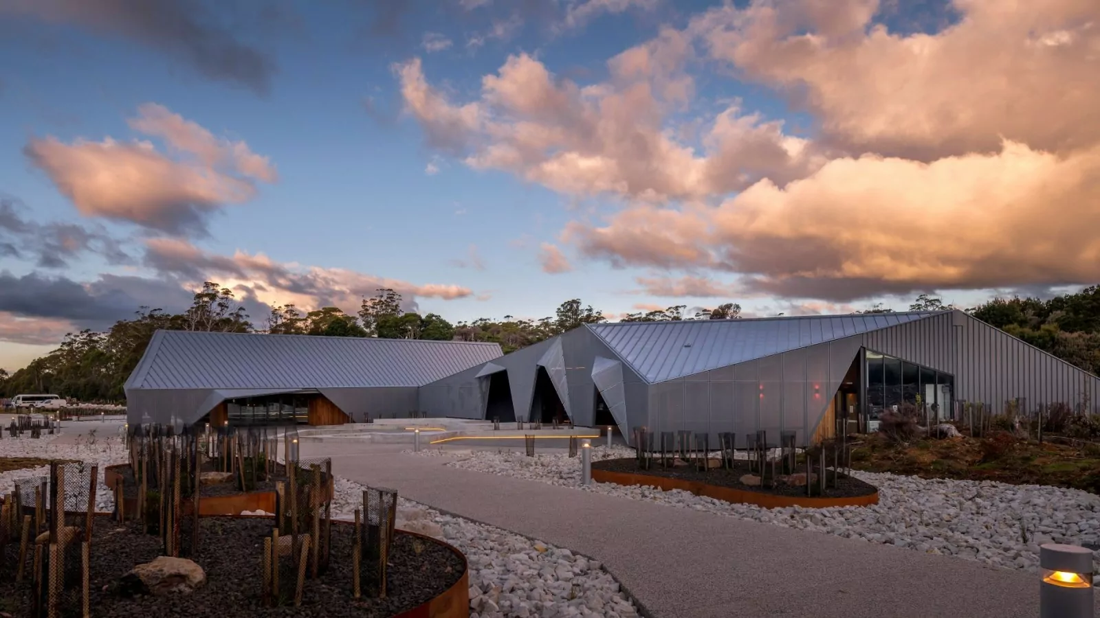 A view of the Cradle Mountain Gateway from one of the pedestrian walkways. Native trees are visible throughout the background behind the building.