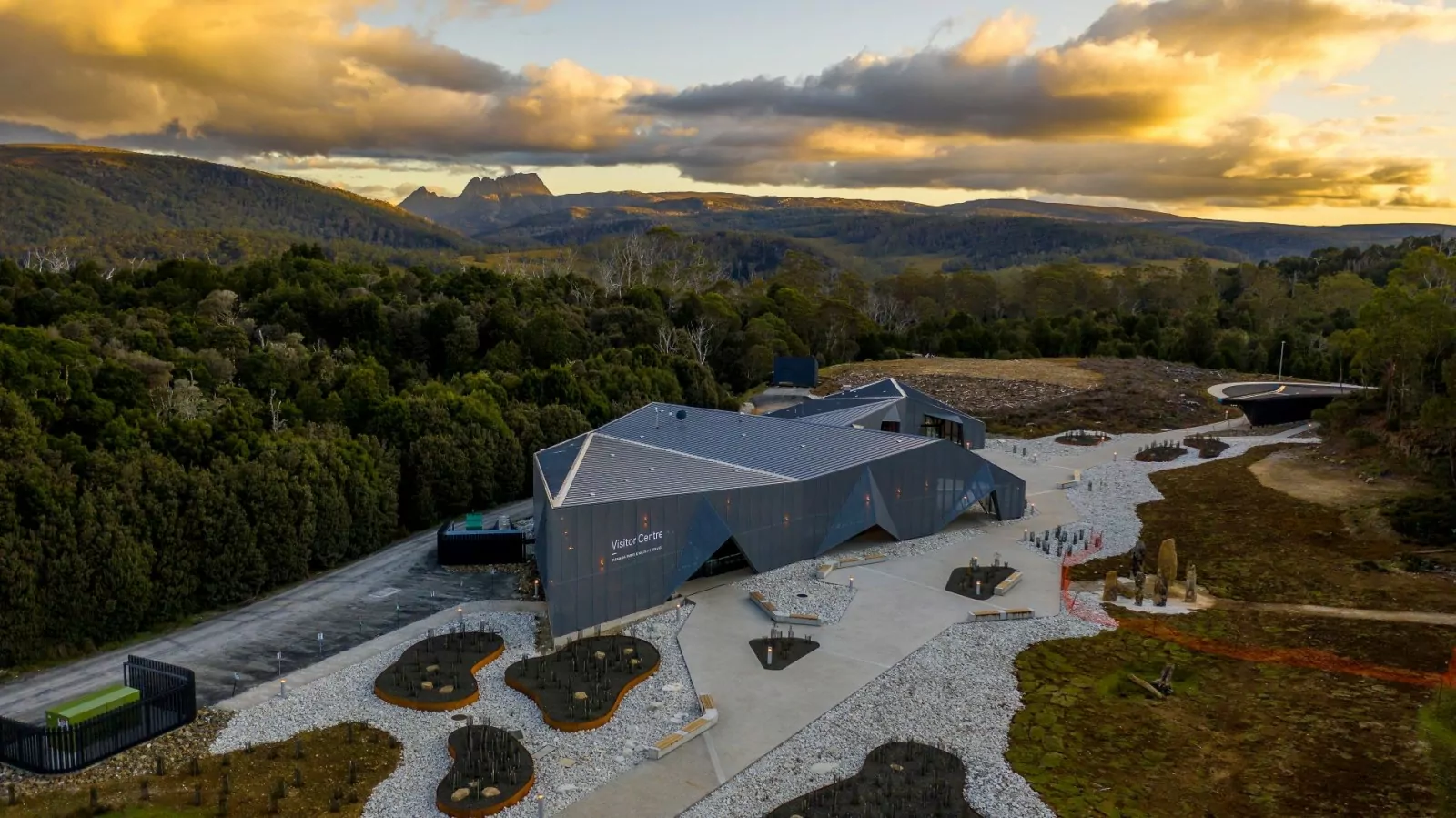 An aerial drone photo of the Cradle Mountain Gateway where the gorgeous surrounding trees and mountain scenery dominates the view.