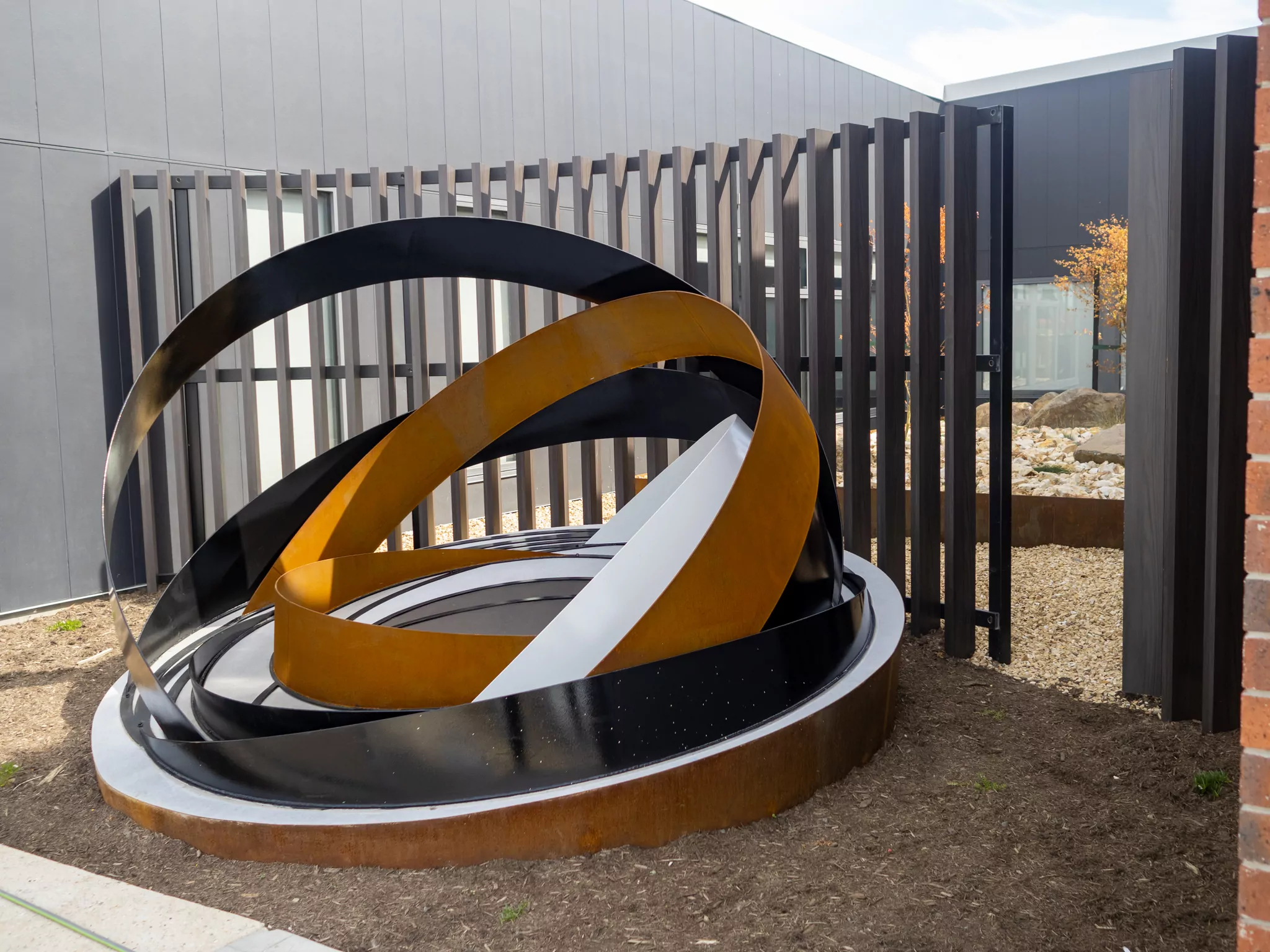 A semi-cypherical metal statue outside of the Sorell Emergency Services Hub.